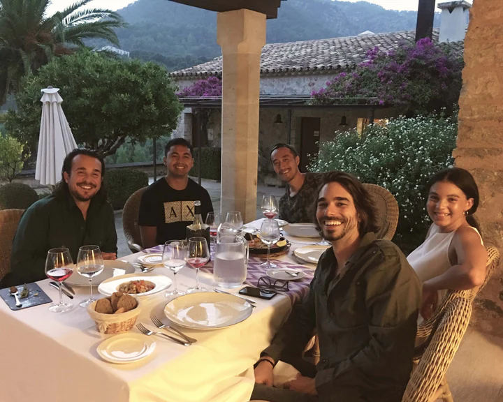Our People - A group of five people sitting around a table